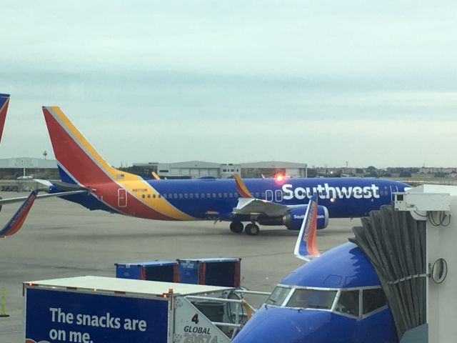 N8710M — - Southwest’s first MAX (N8710M) being towed around the ramp in DAL just two days before its inaugural passenger flight. N645SW in the foreground is preparing for its last passenger flight in its life as the 737-300 series is put to rest in the United States.