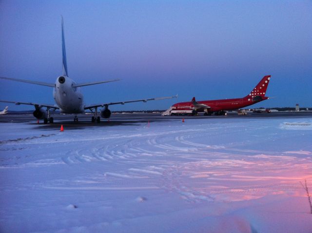 Airbus A330-200 (OY-GRN) - An Air Greenland A330-200 in Fairbanks for the Arctic Winter Games, next to a Yamal Airlines A320.