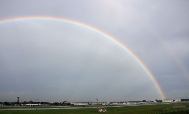 — — - June 18, double rainbow over airport after storm.