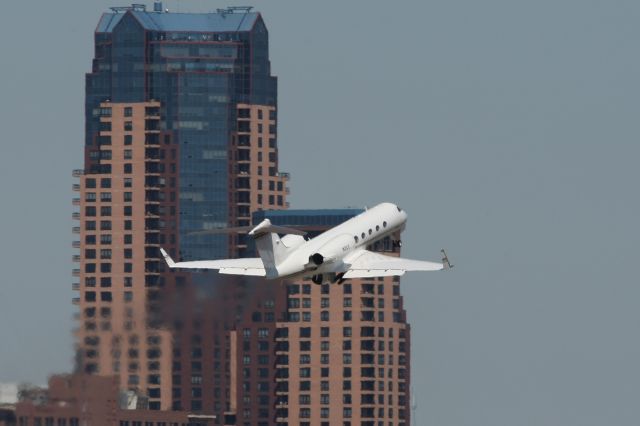 Dassault Falcon 2000 (N2CC) - The Carlson Companies Gulfstream IV    Departing from runway 32.  Downtown St. Paul is in the background