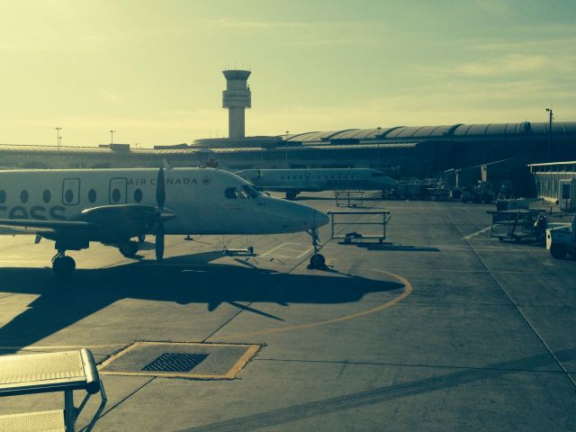 — — - Georgian B1900 and RJ-100 beside each other on the transborder ramp at YYZ