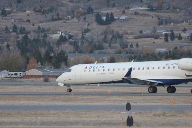 Canadair Regional Jet CRJ-700 (N713EV) - N713EV taxiing to runway 12 at Butte as SKYWEST 4312 to KSLC.br /br /Taken 18:07, November 2, 2024 with a Canon EOS T2i and 70-300mm (300mm, 1/250, ƒ5.6, ISO 3200)