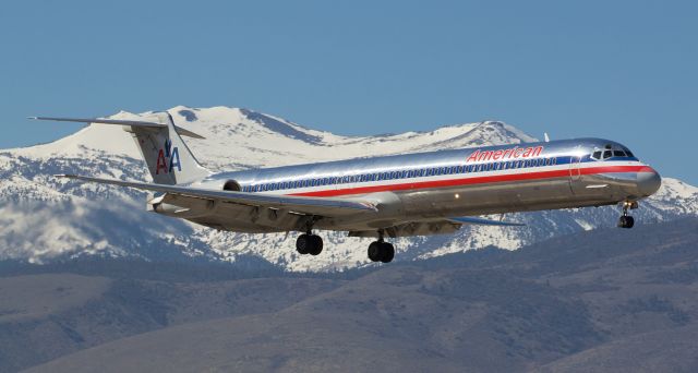 McDonnell Douglas MD-82 (N585AA) - This old Mad Dog (N585AA, an MD-82), dressed up in the now outdated R, W, and B on silver livery, still looks pretty dang good as it glides past Mt. Rose while completing a late morning (11:10 AM) short final to Reno Tahoe Internationals runway 34R.  