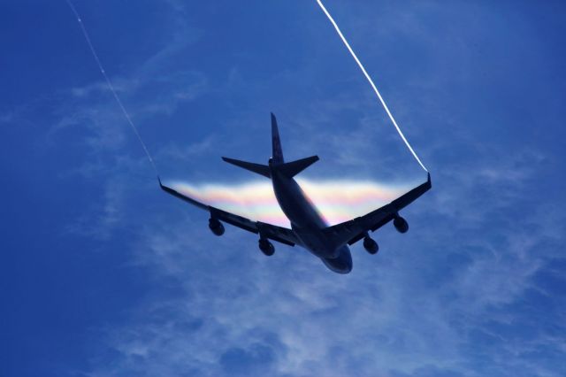 Boeing 747-400 (B-18725) - Water evaporates off the B744 after going through thick cloud.