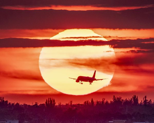 Airbus A321 — - Sunset at Palm Beach International. Pure luck an Airbus flew into the frame as I photographed the Florida sunset.