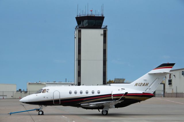 Hawker 800 (N12AH) - N12AH is about to be towed into a hanger at Elliott Aviation FBO with the main DSM tower in the background as a storm system passes to the west of the field. Photo taken August 8, 2020 with Nikon D3200 at 85mm.