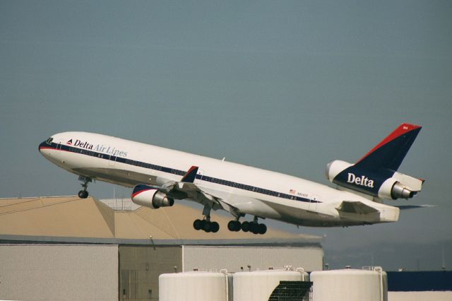 Boeing MD-11 (N804DE) - Before I switched to digital photography I used to have a disc made of my film images. Heres one from about 18 years ago. This aircraft went on to serve with World Airways and UPS.