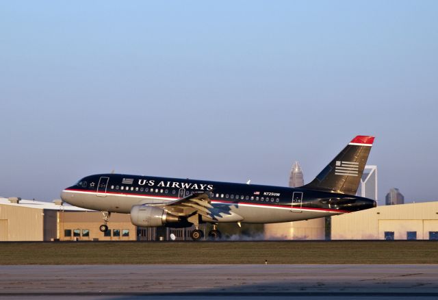 Airbus A319 (N725UW) - This "blue top" 319 makes an evening arrival at Charlotte, NC USA. Downtown is in the distance.