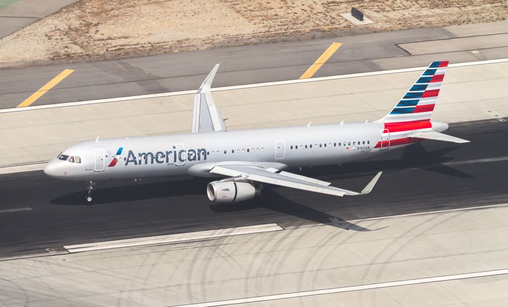 Airbus A321 (N160AN) - AAL2480 touches down on runway 25L at LAX, arriving from Dallas/Fort Worth
