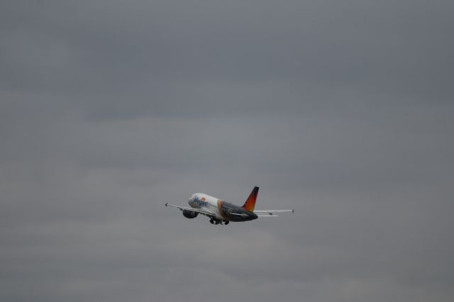 Airbus A319 (N302NV) - Allegiant Airlines's "Golden Knight" A319-100 ascends into the storm