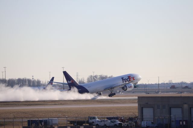 BOEING 777-200LR (N893FD) - The first departure to use the newly-redone Runway 23L/5R after nearly a year! The massive 777 kicks up a huge dust plume as he thunders down the brand-new concrete! Absolutely stunning.