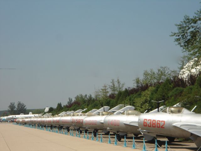 — — - Line up of MiG 15, leading to Chairman Maos airliner, Chinese Aviation Museum.