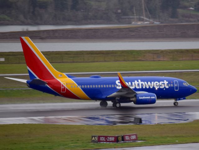 Boeing 737-700 (N7705A) - New southwest departing PDX on a rainy day. 