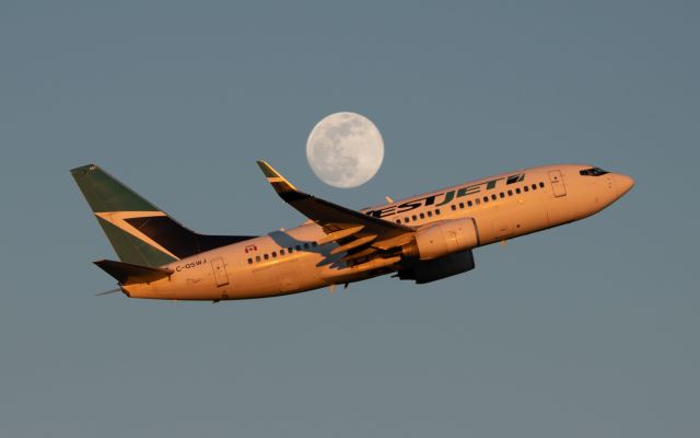 Boeing 737-700 (C-GSWJ) - West Jet heading for the moon, then Calgary, on climb-out from KIAD 16 Jan 2022