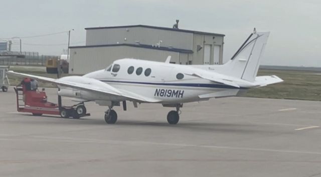 Beechcraft King Air 90 (N819MH) - Being towed to hanger at KGCK. 