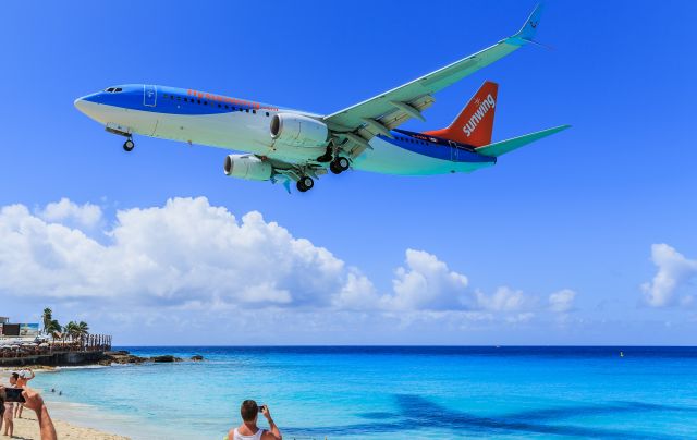 Boeing 737-800 (C-FVWA) - Sun Wing C-FVWA over the maho beach at TNCM St Maarten.