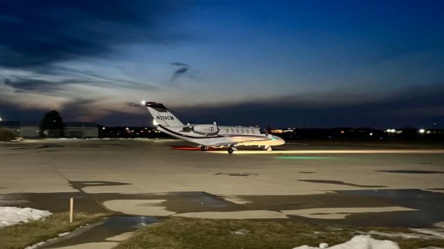 Cessna Citation CJ3 (N219CM) - N219CM, lit up like a Christmas tree with the fading sunset in the background. 1/18/22. 