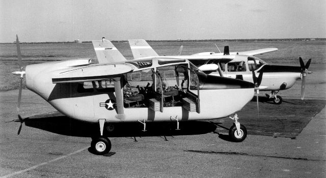 N6309F — - In the background is the O-2TT prototype [demonstrator]. In the foreground is the mocked-up fuselage showing proposed changes for the production O-2TT. The primary change was tandem seating/controls, better avionics, light cockpit armor, large bubble side windows and large over-head windows for panoramic visibility [rivaling the OV-10... at a much lower unit cost]. The wing was also lengthened and strengthened to accommodate added fuel and (2) store-stations permanently mounted [increased wing area and available power = greater performance margin = greater combat payload and endurance over the battle area].