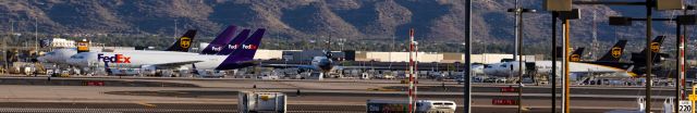 Boeing MD-11 — - Almost full cargo ramp at PHX on 8/1/22. FedEx 767 x2, FedEx MD11, UPS A300-600 x2, UPS MD11 x2, and a UPS 757 (plus 2 FedEx Cessna Grand Caravans). Taken with a Canon 850D and Sigma 150-600 Contemporary lens.