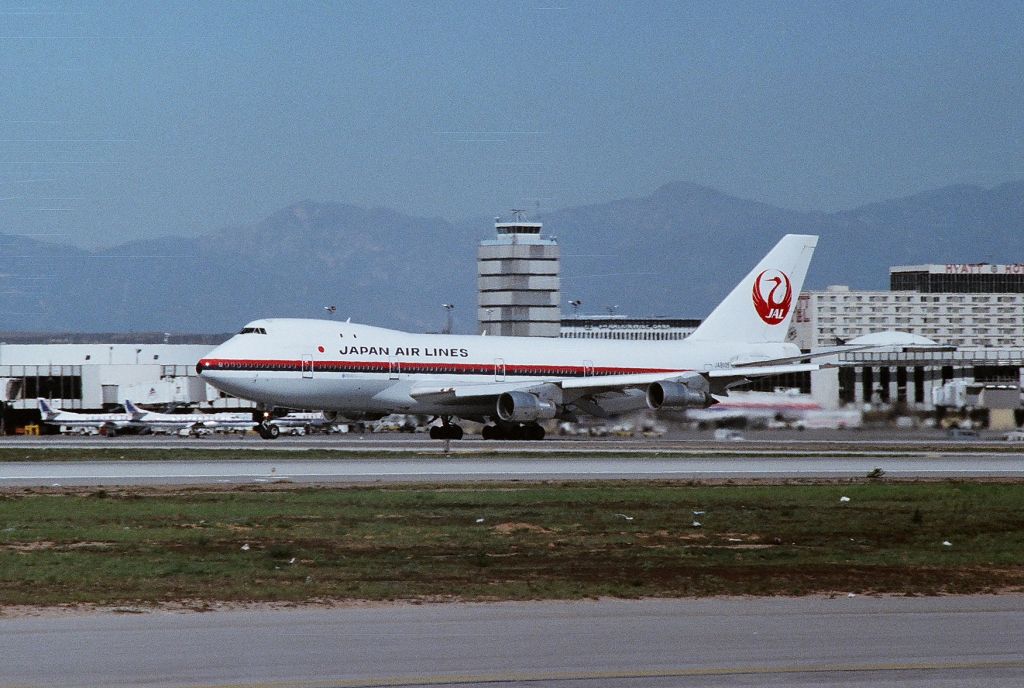 Boeing 747-200 (JA8105) - KLAX - Mar 1989? view of JAL 8105 rolling down 25R on departure for Tokyo. Photo from the old Imperial Terminal Lot. 35mm negative scan.