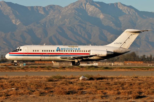 Douglas DC-9-10 (N784TW) - A very roughed up DC-9-15RC operated by Ameristar departs Chino.