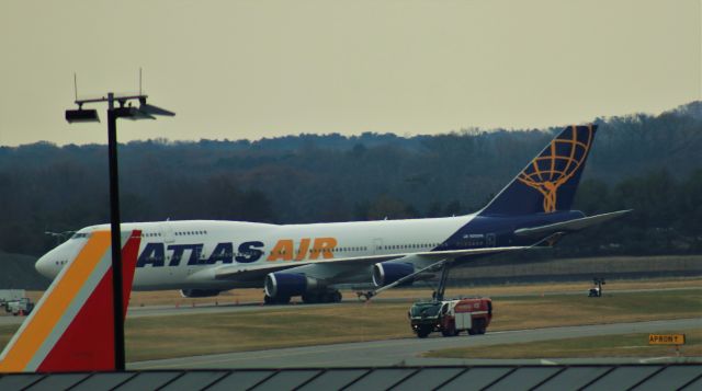 Boeing 747-400 (N322SG) - 12/9/21 Atlas passenger model parked on a remote apron. ARFF Stryker 432 on the station apron.