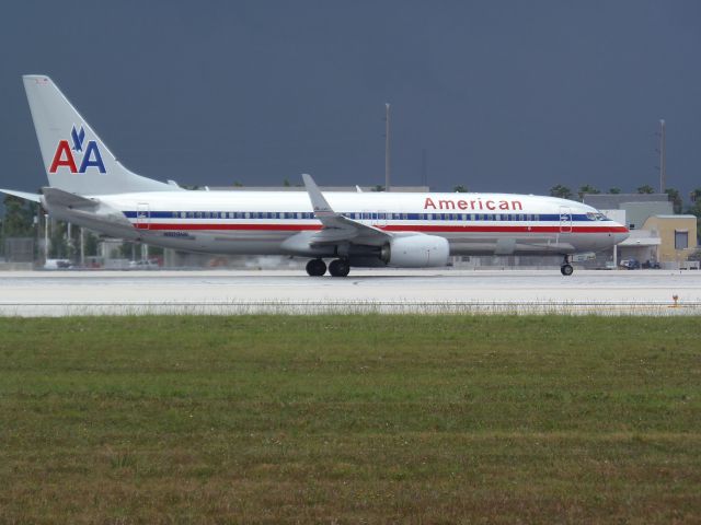 Boeing 737-700 (N909NN) - Taken from the famous photoholes at Miami International! N909NN contemplates it's takeoff run under threatening skies! MIA April 13th 2013/Geoff