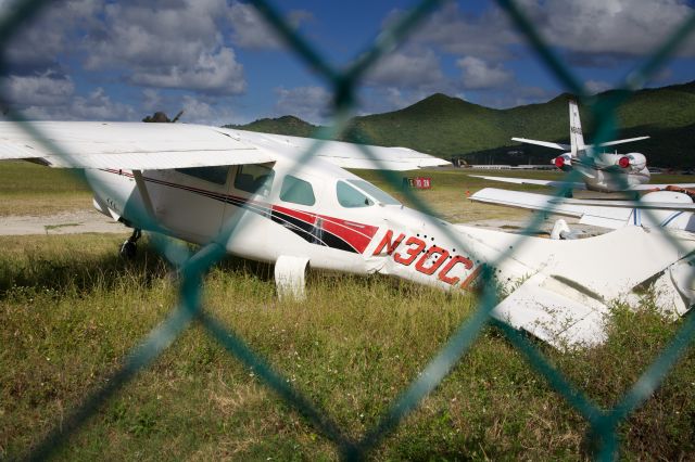 Cessna Centurion (N30CL) - This rather sad Cessna 210, sitting off the GOLF Ramp in Sint Maarten, seems to have suffered a major mishap..