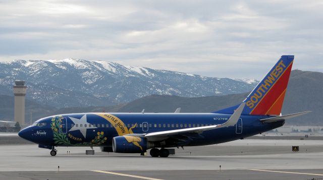 Boeing 737-700 (N727SW) - SWAs "Nevada One" makes the turn at the north end of Reno Tahoe Internationals Alpha taxiway and moves to the runway 16R hold line.