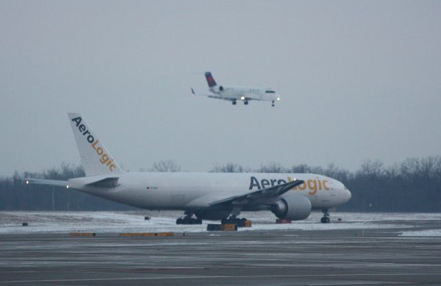 Boeing 777-200 (D-AALF) - AeroLogic awaiting clearance for take off on 18L on a cloudy day.