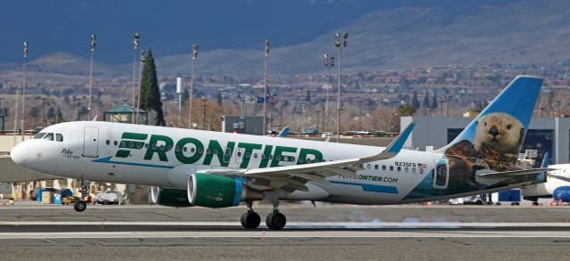 Airbus A320 (N235FR) - "Pike the Otter" (N235FR), an FFT A320 fleetbird, gets a bit of burn on its back "paws" as it touches down on the runway 16R concrete a couple of minutes before 12 oclock noon while landing at Reno Tahoe International at the end of a trip from Denver (KDEN).