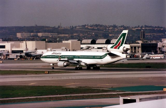 Boeing MD-11 (I-DUPE) - KLAX - Imperial Hill photo of an Alitalia MD-11 arriving at LAX - photo date apprx 1994.
