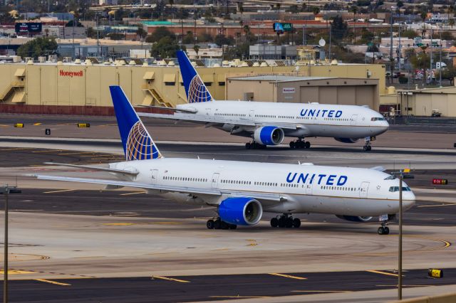 Boeing 777-200 (N779UA) - A pair of United Airlines 777-200 landing and taxiing at PHX on 2/13/23, the busiest day in PHX history, during the Super Bowl rush. Taken with a Canon R7 and Canon EF 100-400 II L lens.