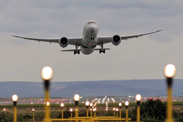 Boeing 787-9 Dreamliner (HZ-ARA) - SVA124 departing for Jeddah as seen through the landing lights on 05L with EK17 (A6-EUA) on approach in the background.