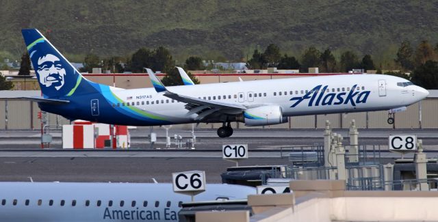 Boeing 737-900 (N317AS) - Alaska's N317AS is captured here just before it was about to disappear behind the Concourse C rooftop as the B739  was flaring out to touch the mains on to Runway 16R. N317AS was arriving from Seattle.