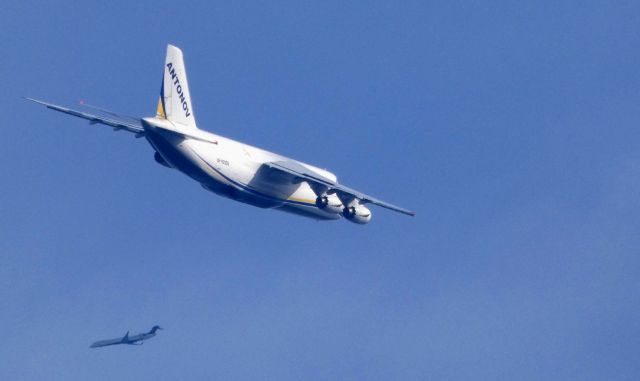 Antonov An-124 Ruslan (UR-82009) - This former Russian Air Force Quad-Jet is a few minutes until landing. Records show it was in the military service from 1986 to 1993 when it was transferred to Antonov Design Bureau. Also passing by is a Delta Connection CRJ-900. Port side passengers may of caught a glimpse of this large aircraft. Shown here in the Autumn of 2018.