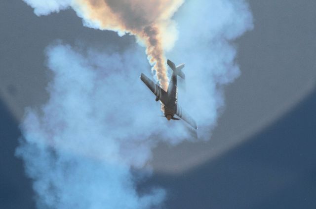 YAKOVLEV Yak-52 (VH-YRO) - Immersed in his own smoke during airshow routine - I enjoyed the effect of the sun behind the plane and smoke and the shadows it created