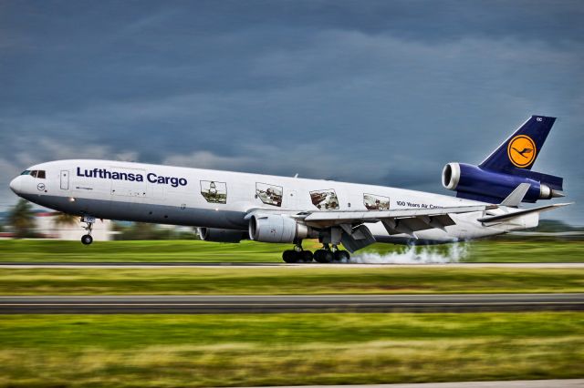 Boeing MD-11 — - Lufthansa Cargo (100 Years of Air Cargo) burning some tires on Rwy 8.