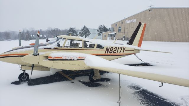 Piper PA-30 Twin Comanche (N8217Y) - Picture taken before clearing the tail of snow. Don't want it to do a wheelie. Beautiful colors, love tan aircraft.