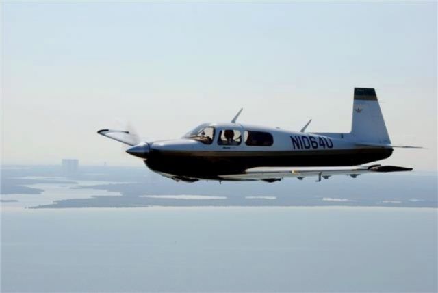 Mooney M-20 (N1064U) - Flying past Kennedy Space Center  One day before launch. Shuttle on its pad.