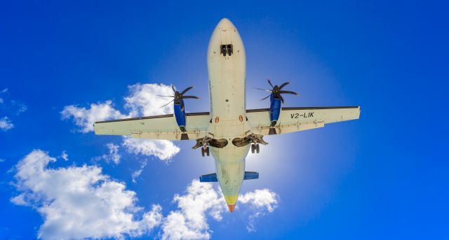 V2-LIK — - Liat over maho beach for landing at TNCM St Maarten.