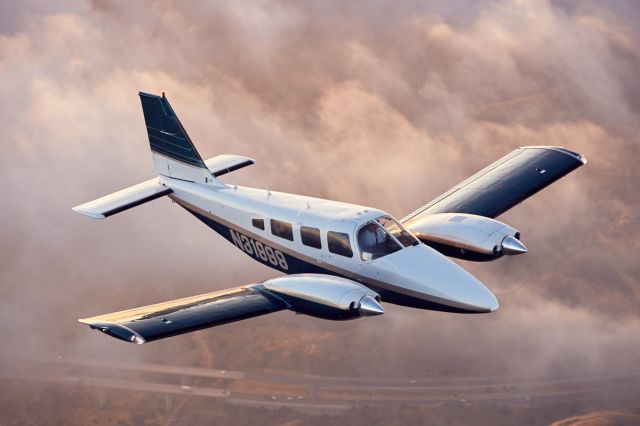 Piper Seneca (N31999) - Over the CA-241 toll road 30 nm East of KSNA at 4,000. Photo by Mike Fizer.