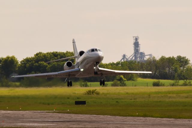 Dassault Falcon 900 (C-GNTR) - Dassault Falcon 900 departing Yorkton with the canola crushing plant in the background