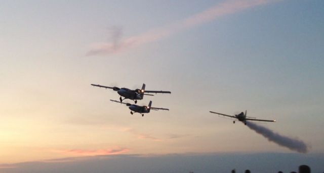 — — - End of the night formation flight of two twin otters and a S2R crop duster... at Redemption Boogie 2012.