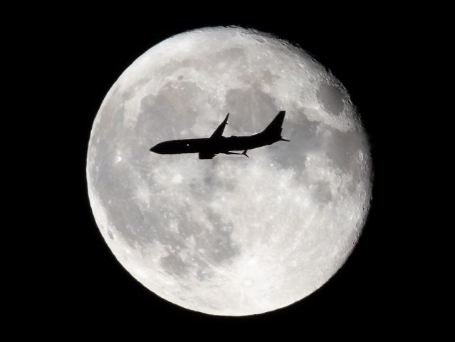 Boeing 737-800 (N8327A) - Southwest 2935 crossing the moon on approach to LaGuardia.  Taken 8/2/2023.