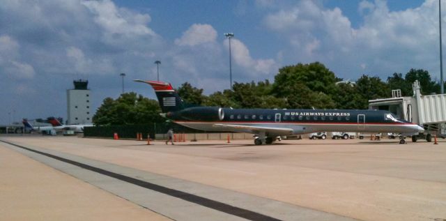 — — - A classic shot of an old US Airways Express ERJ-145.  In the background you can see a Delta Connection CRJ with the colors in motion livery.  Taken back in 2009.