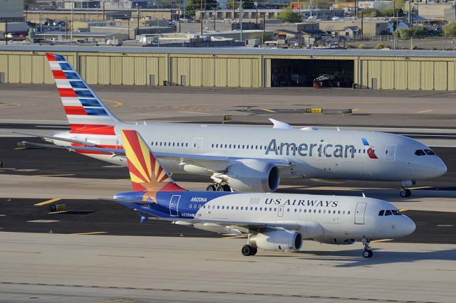 Airbus A319 (N826AW) - US Airways Airbus A319-132 N826AW Arizona taxis past American Boeing 787-823 N801AC at Phoenix Sky Harbor on March 10, 2015.