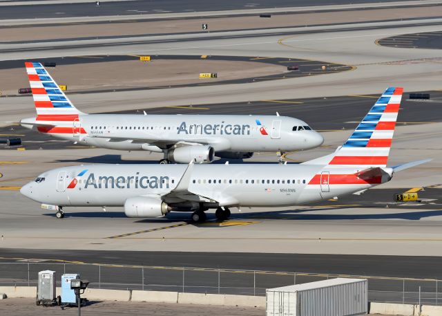 Boeing 737-800 (N968NN) - N968NN (B738) is taxing on S while a company A320 (N665AW) is taxing of T. 