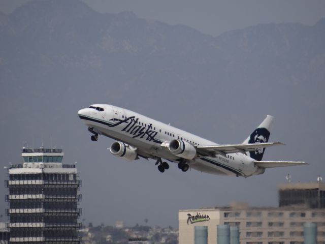 BOEING 737-400 (N703AS) - Alaska B734 taking off over the old LAX tower