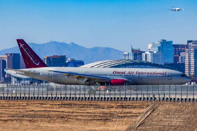 Boeing 777-200 (N828AX) - An Omni Air International 777-200 landing at PHX on 2/10/23 during the Super Bowl rush. Taken with a Canon R7 and Canon EF 100-400 II L lens.